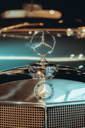 gold and silver car hood ornament