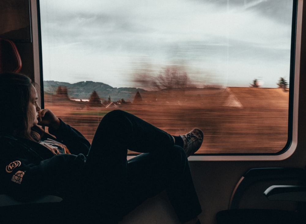 man and woman sitting on car