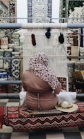 An artisan working on a loom, weaving synthetic staple fibers.