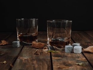 clear drinking glass on brown wooden table