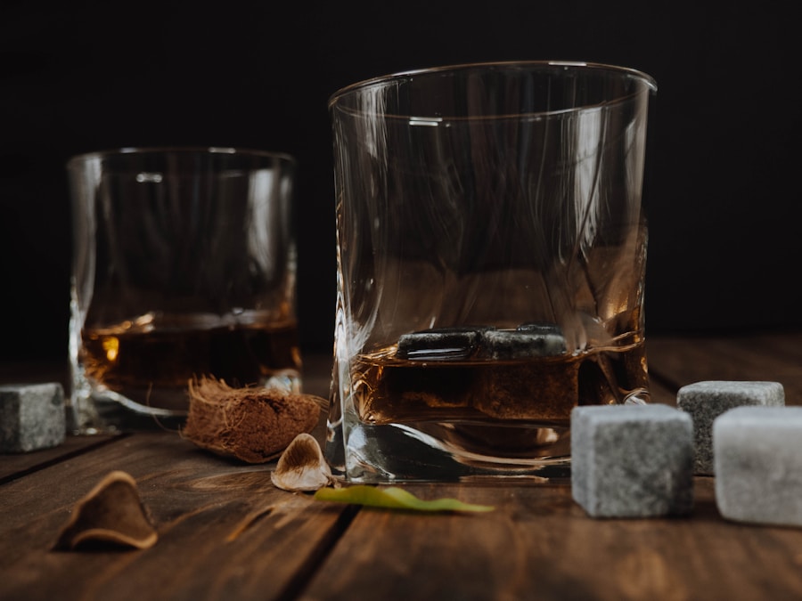 Bourbon glass and cigar on dark surface