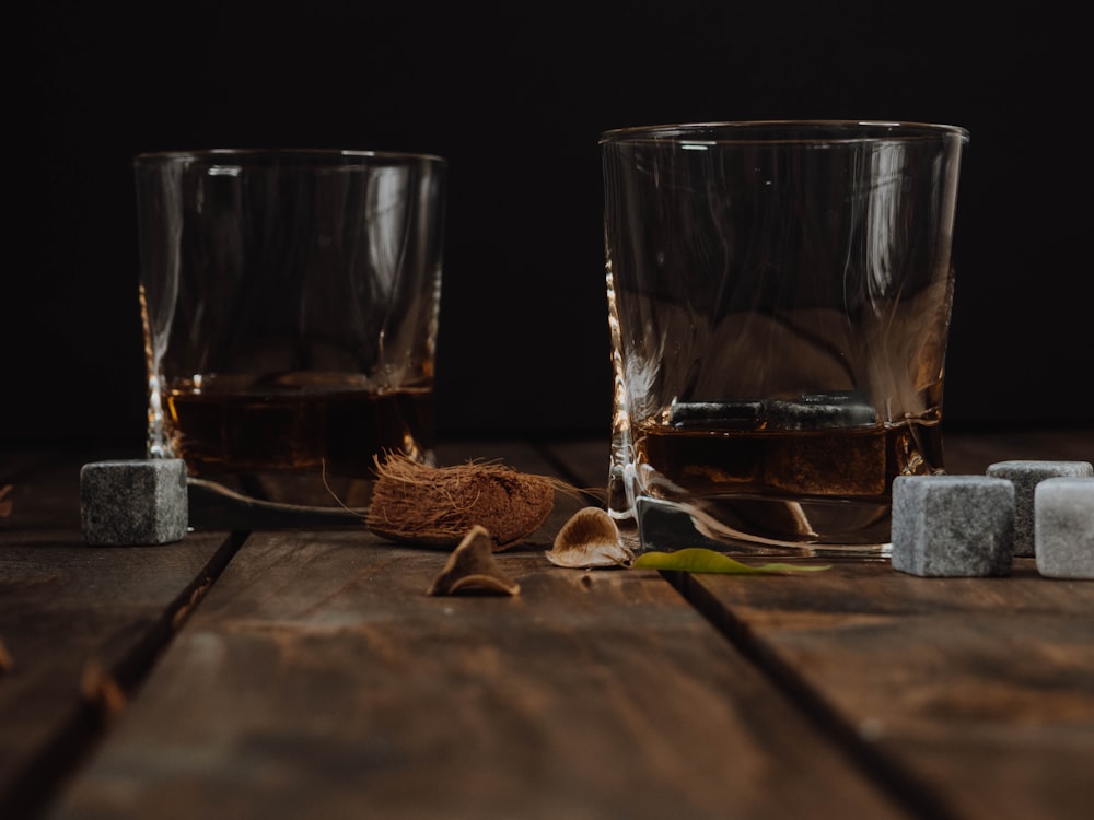 a couple of glasses sitting on top of a wooden table