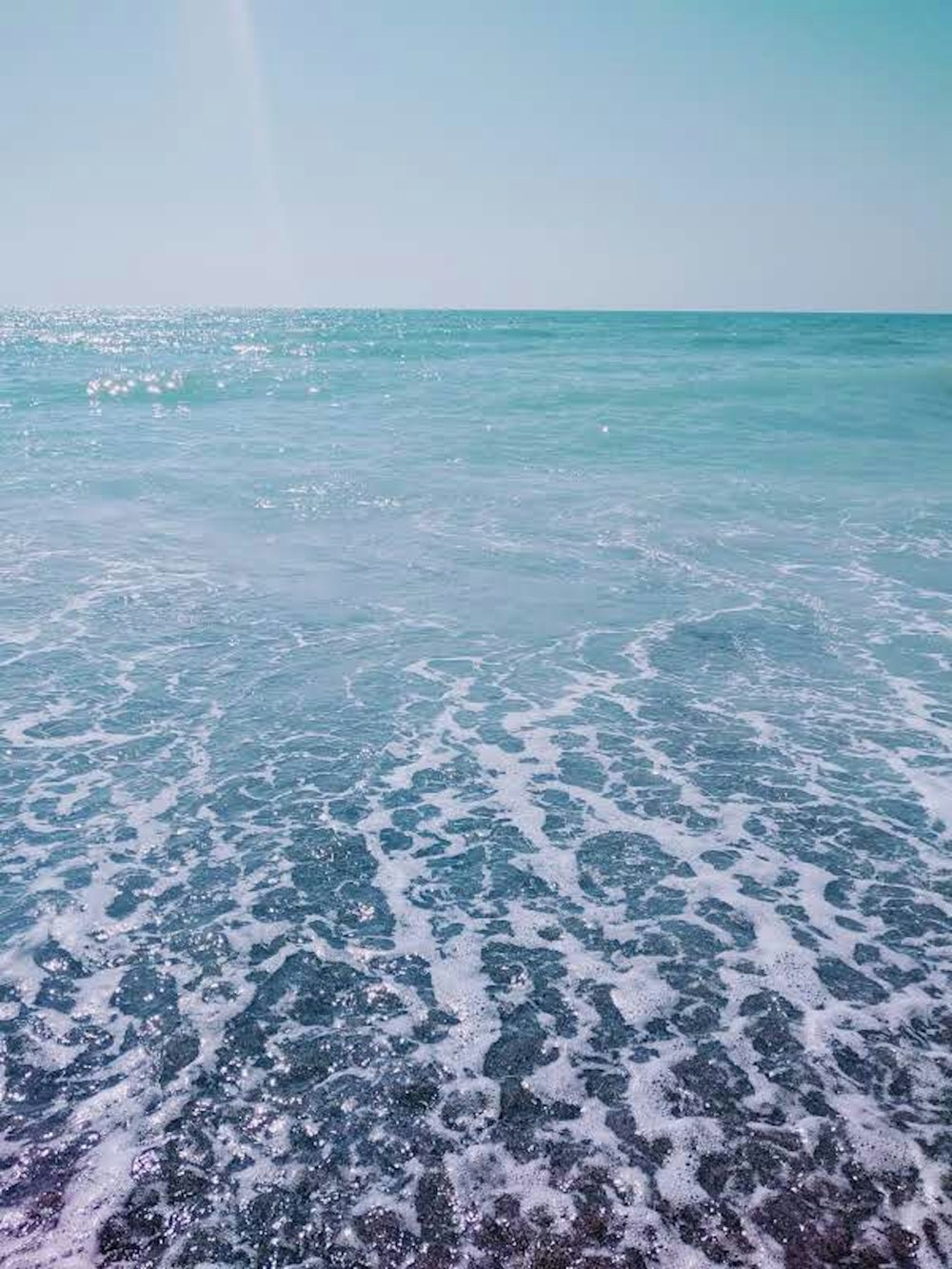 body of water under blue sky during daytime