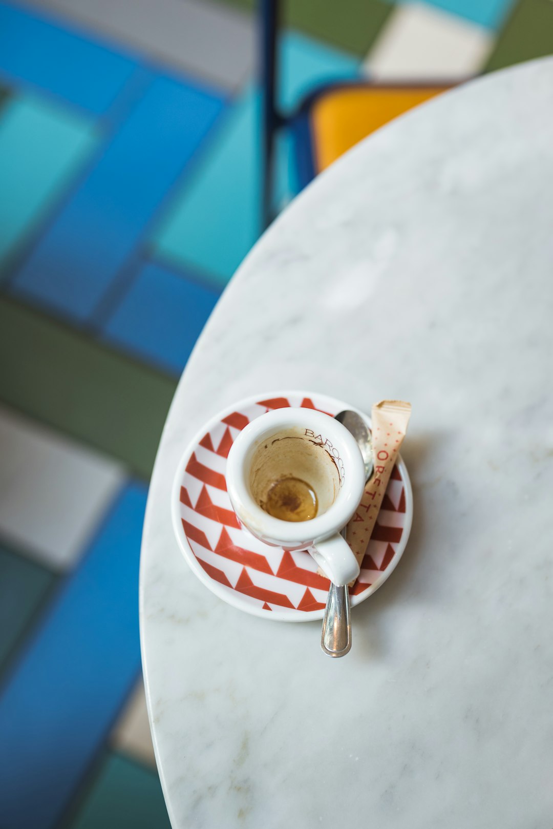 white and red ceramic mug on white table