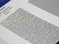 Metallic service cards with subtle vibration effect displayed on an industrial panel.