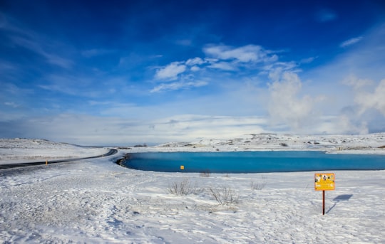 white snow covered field under blue sky during daytime in Mývatn Iceland
