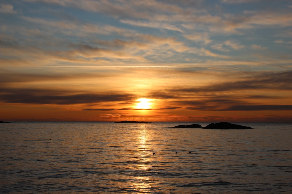 body of water during sunset