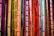 Colorful ribbons featuring words related to gender identity and sexual orientation hang vertically. Each ribbon displays labels like lesbian, bisexual, intersex, transgender, and ally, among others. The ribbons are in a vibrant array of shades, creating a rainbow effect.