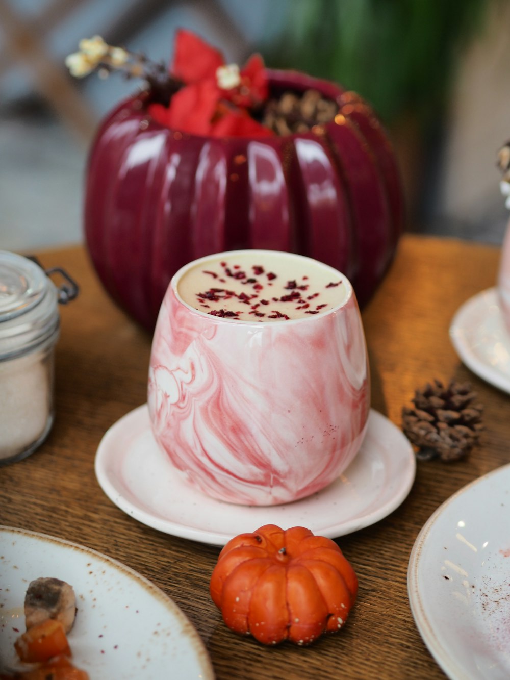 white and pink floral ceramic mug with saucer