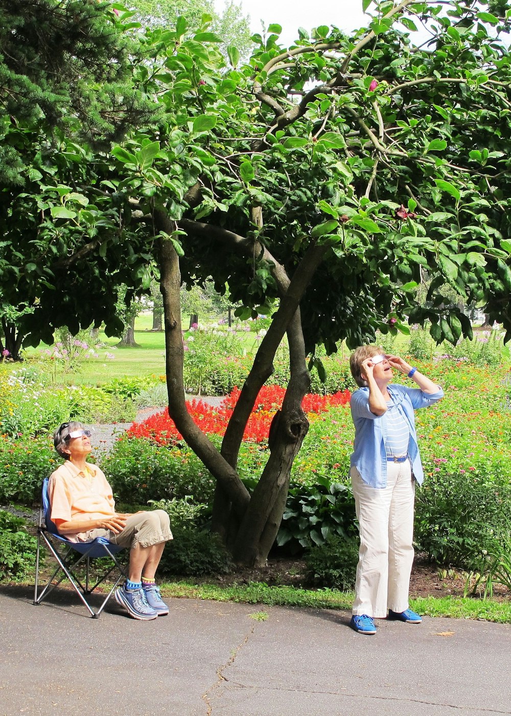 man in white t-shirt and blue denim jeans standing beside woman in pink t-shirt