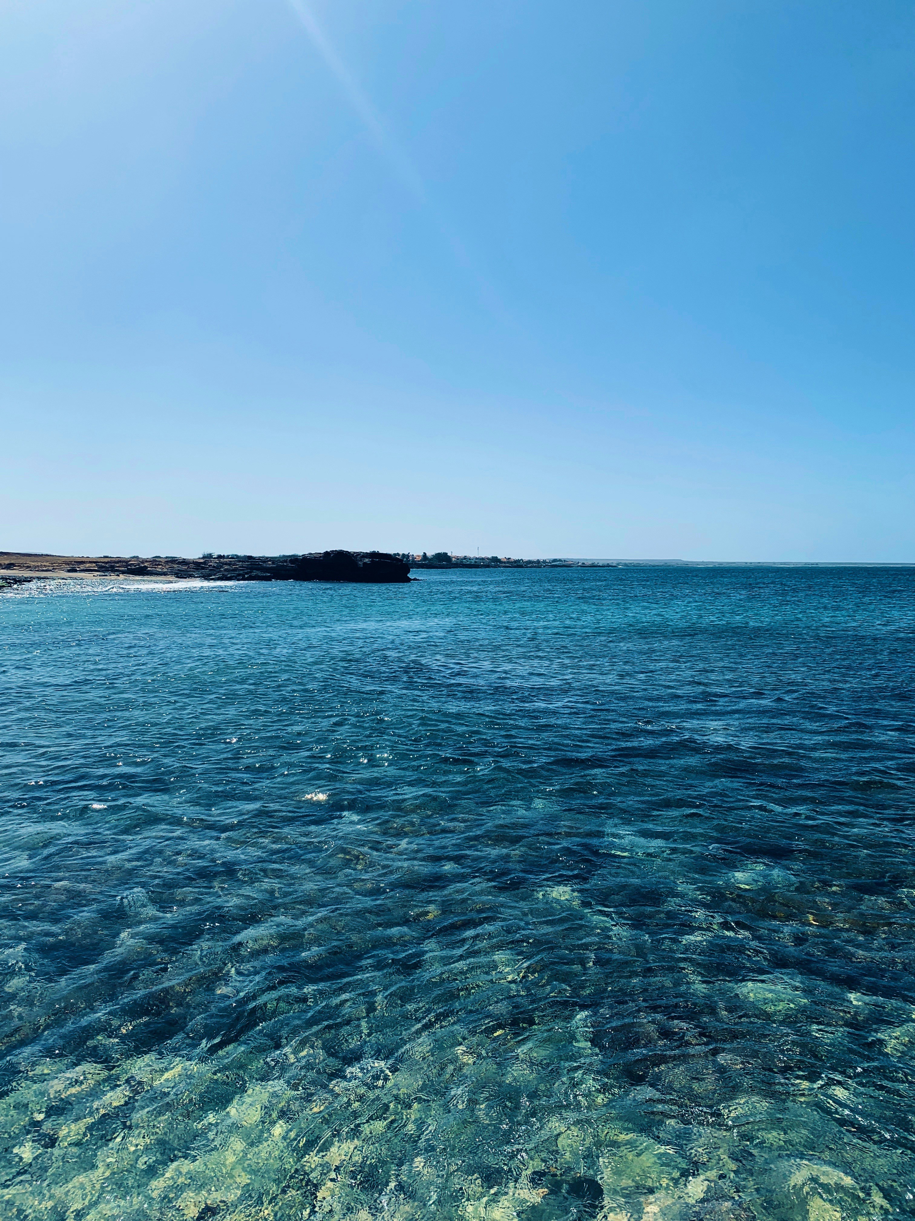 blue sea under blue sky during daytime