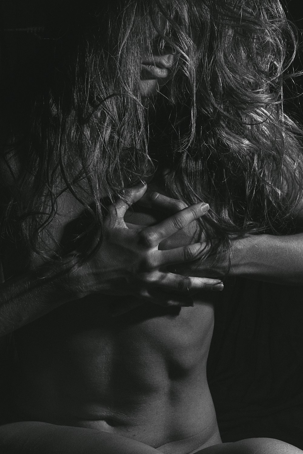 grayscale photo of woman covering her face with her hands