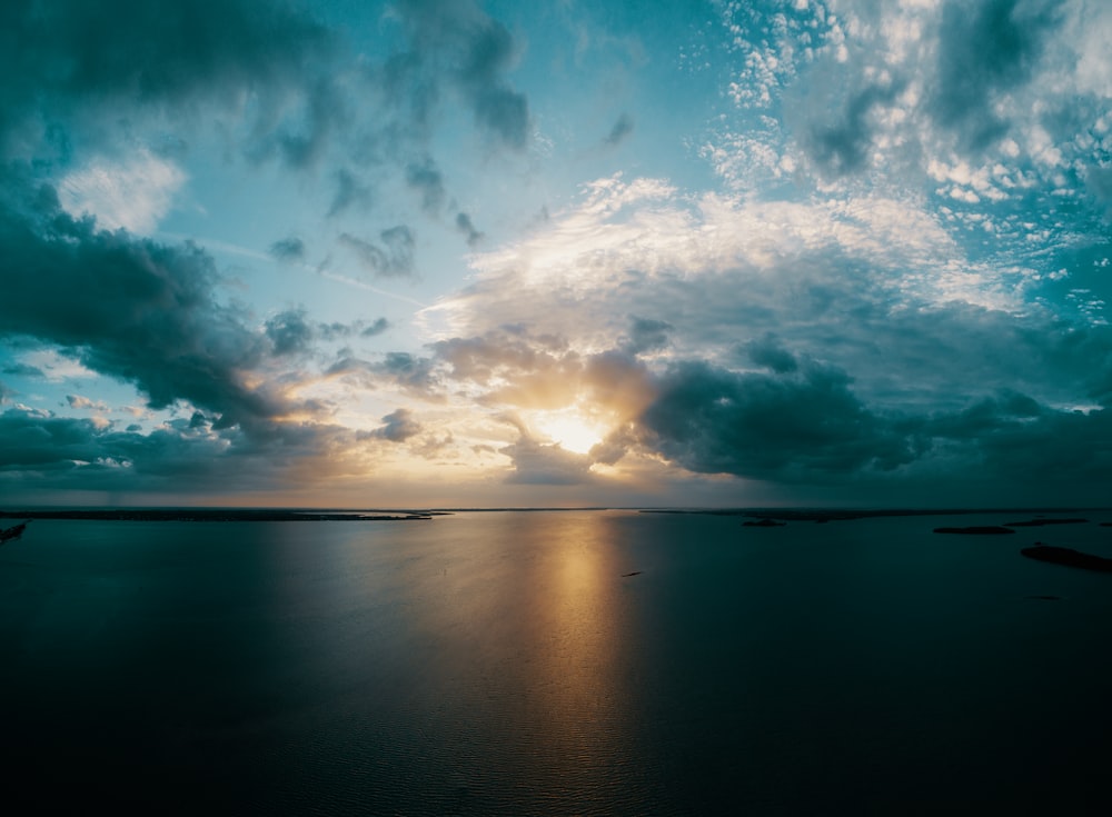 blue sky and white clouds over calm sea