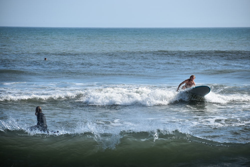 man surfing on sea waves during daytime