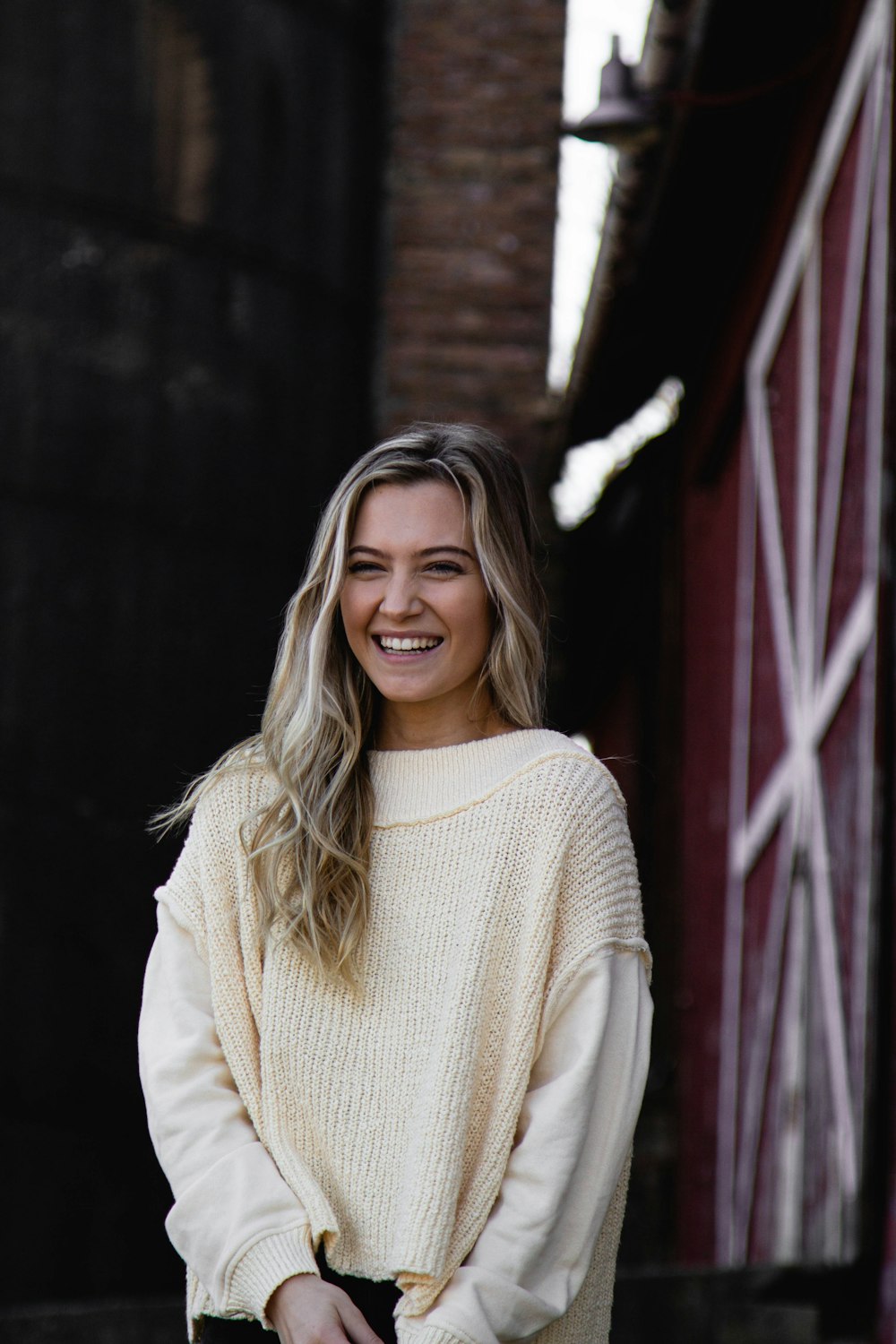 smiling woman in white knit sweater