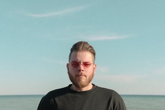 man in black crew neck shirt wearing eyeglasses in Lake Ontario Canada