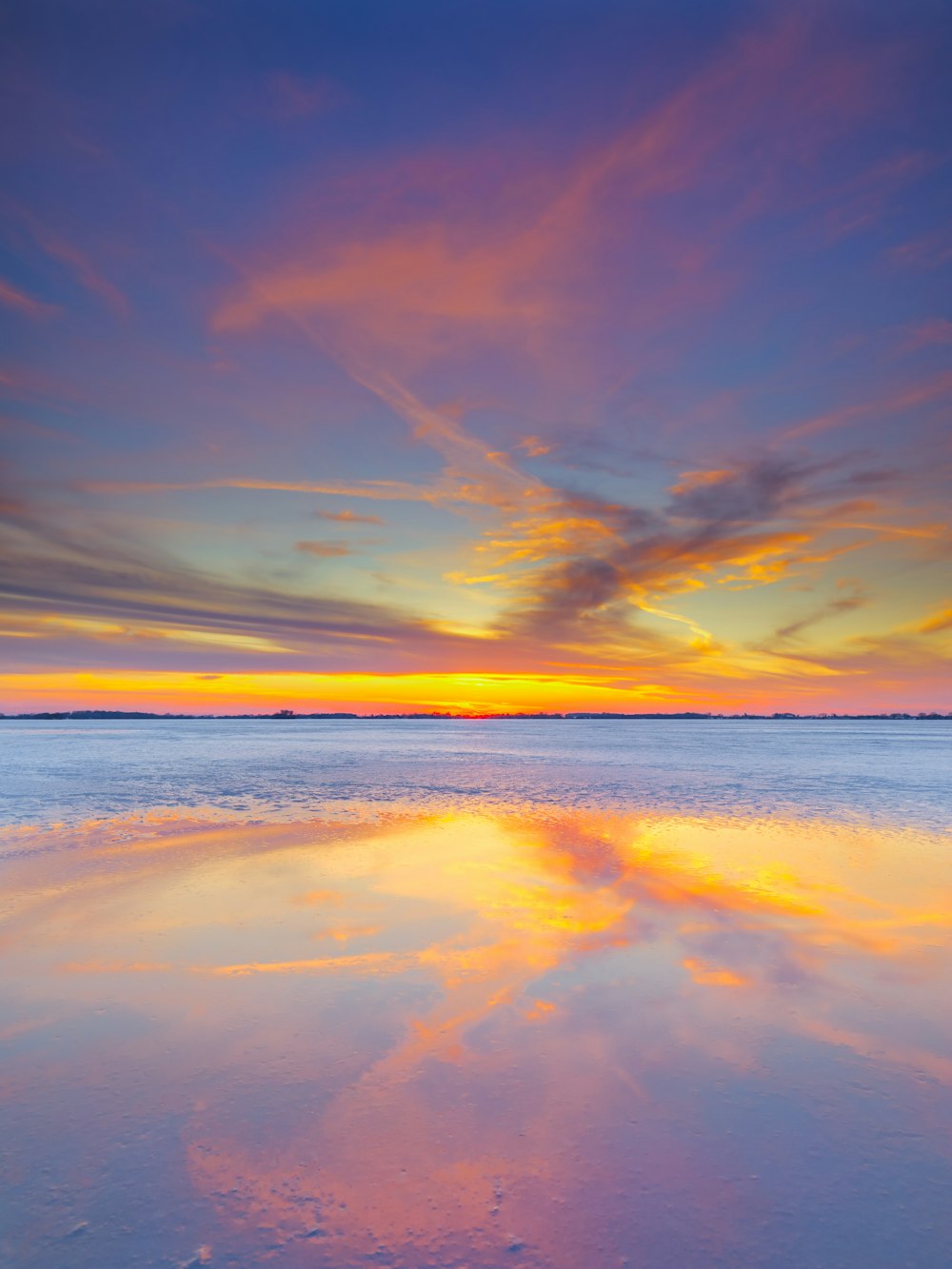 body of water under blue sky during sunset