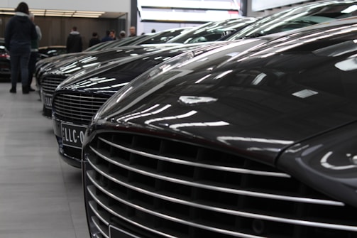 Rows of high-end vehicles parked inside a clean, organized service center.