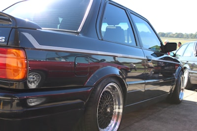 A freshly replaced windshield shining on a parked vehicle under sunlight.