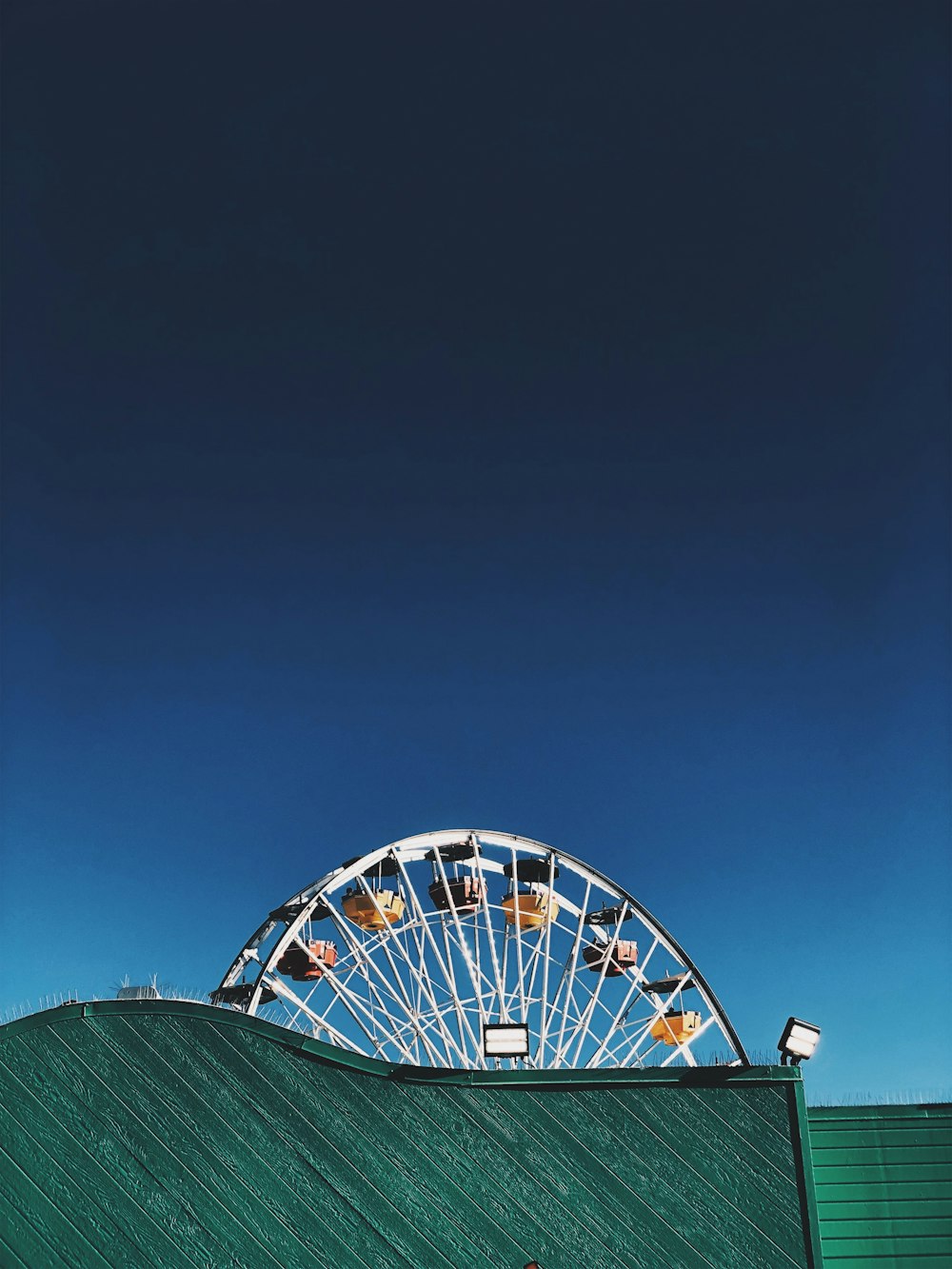 green and white ferris wheel under blue sky during daytime