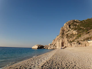 brown rock formation on beach during daytime