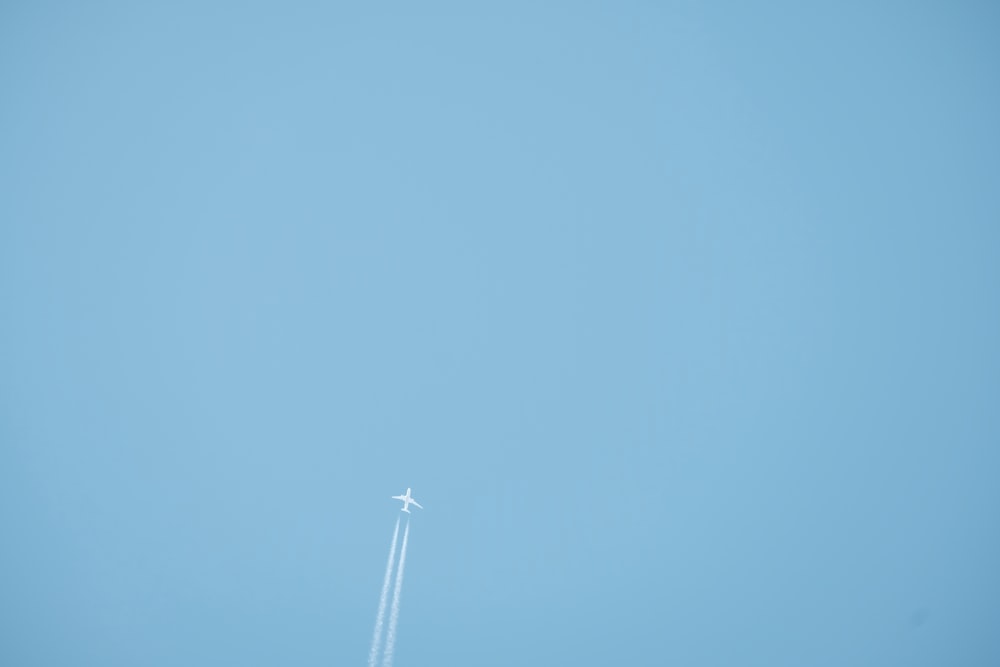 white wind turbine under blue sky during daytime