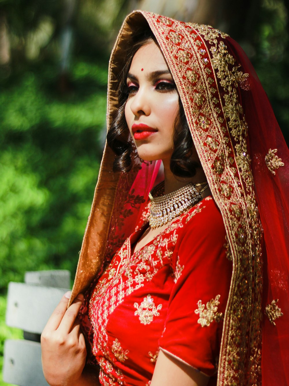 woman in red and gold floral hijab