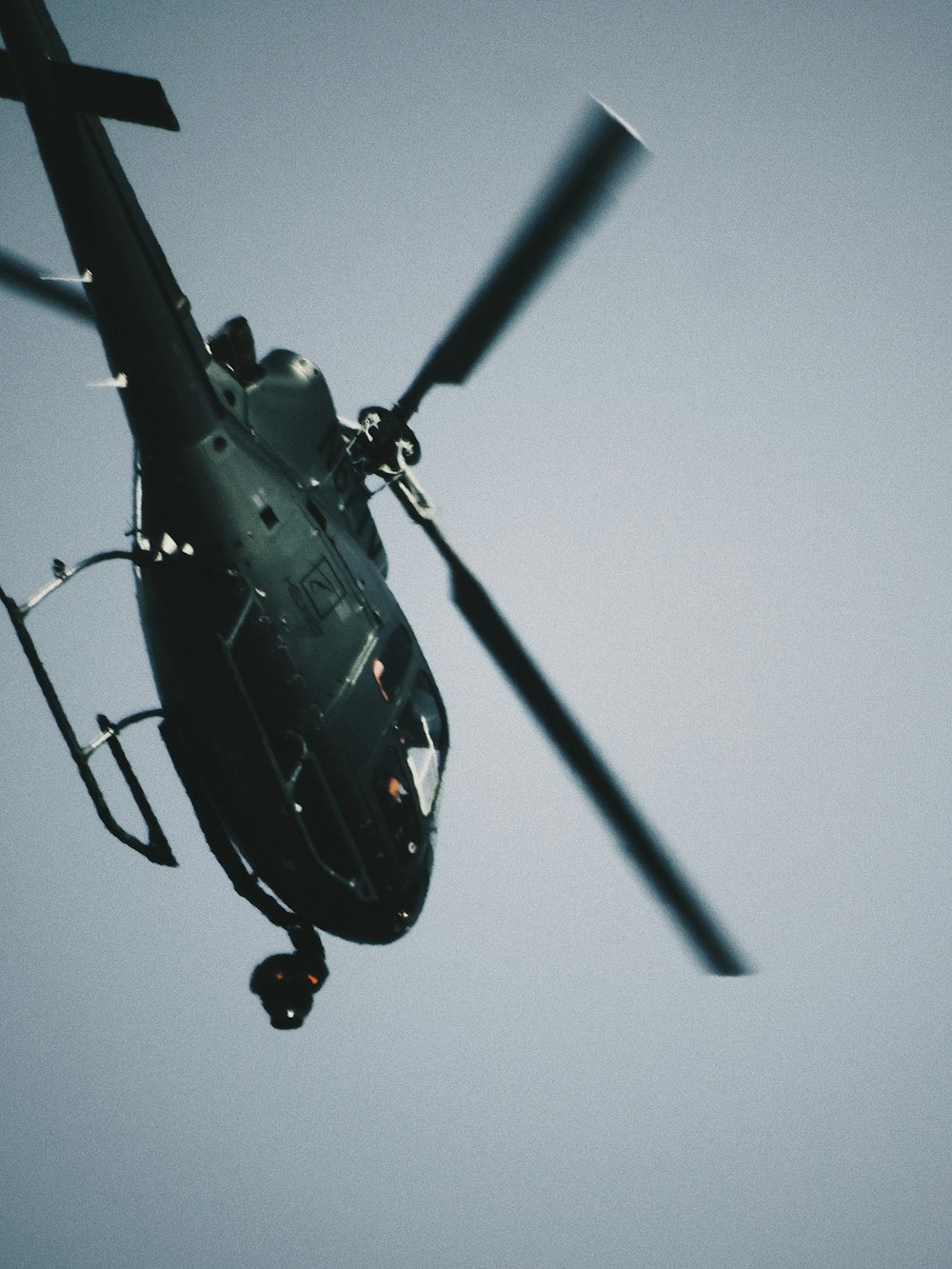 black helicopter flying in the sky