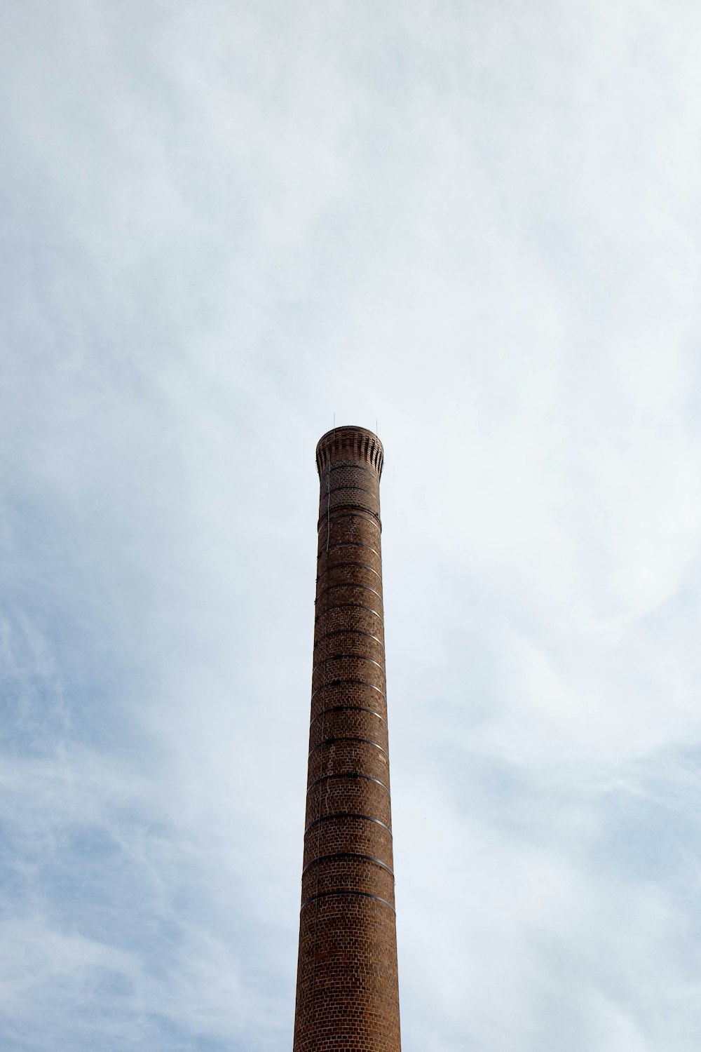 brown concrete tower under white clouds during daytime