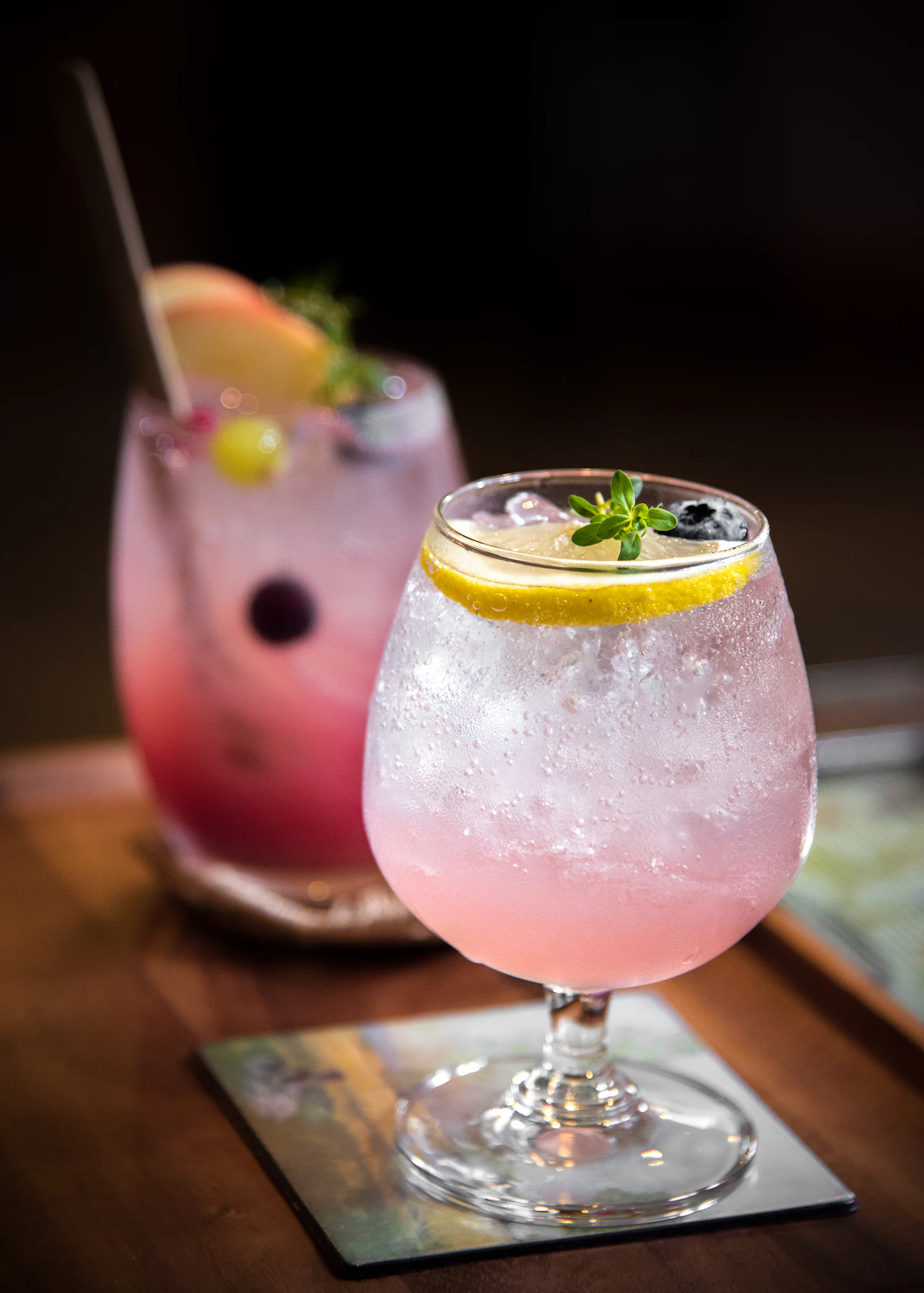 A blush signature cocktail in a stemmed glass