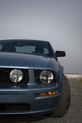 Front view of a blue SUV with highlighted replacement parts.