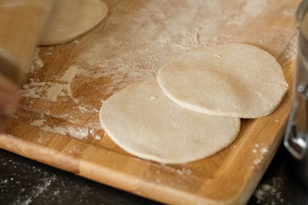 white dough on brown wooden chopping board