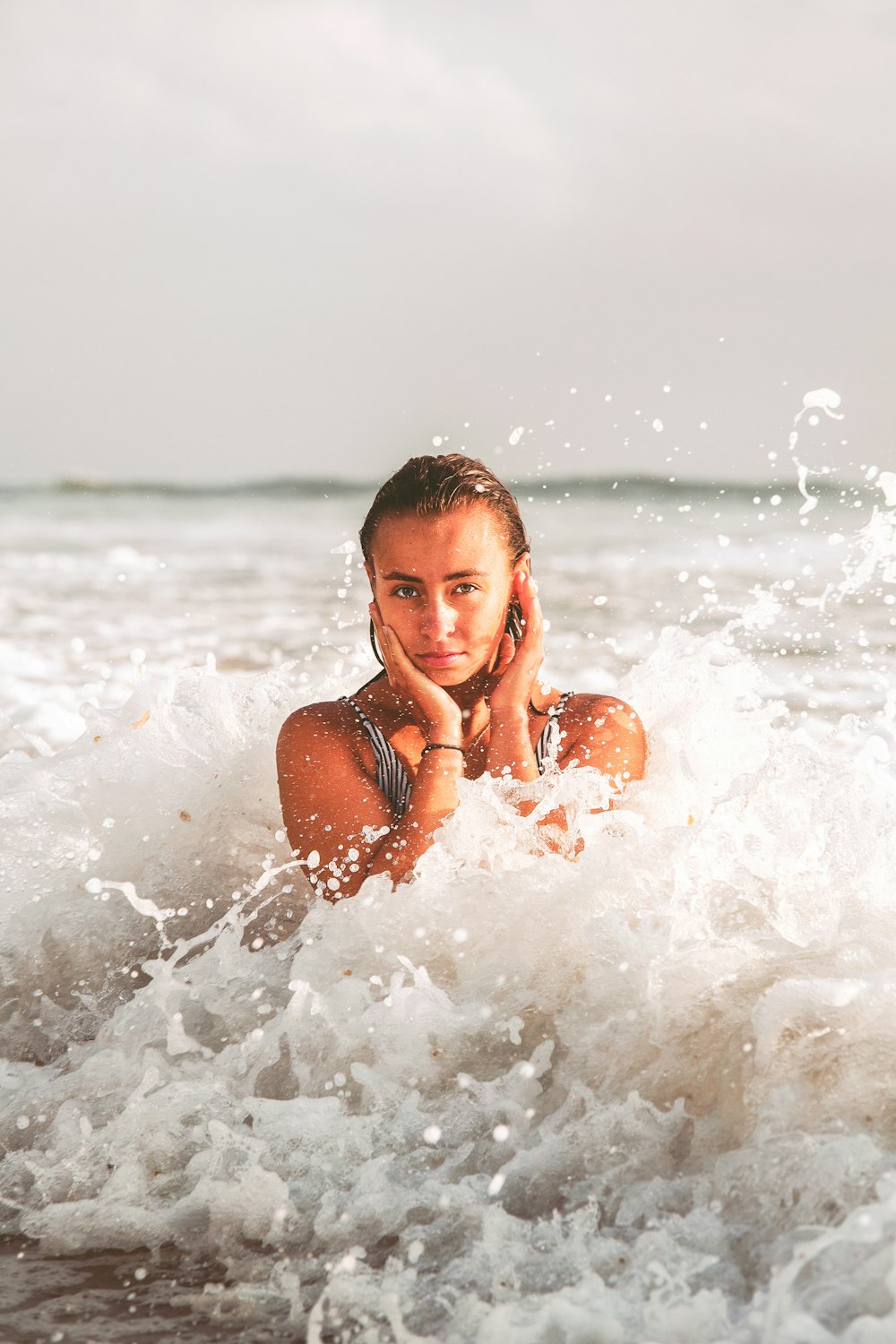 woman in black bikini top on water