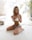 woman in white brassiere and panty sitting on bed