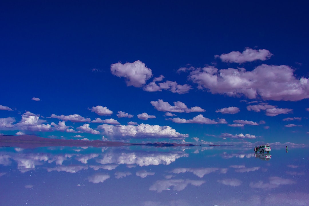 blue sky and white clouds over calm sea,