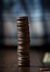 gold round coins on brown wooden table