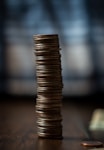 gold round coins on brown wooden table