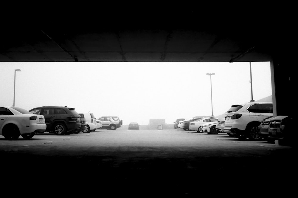 grayscale photo of cars on parking lot