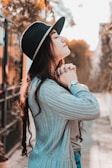 woman in black hat and gray sweater