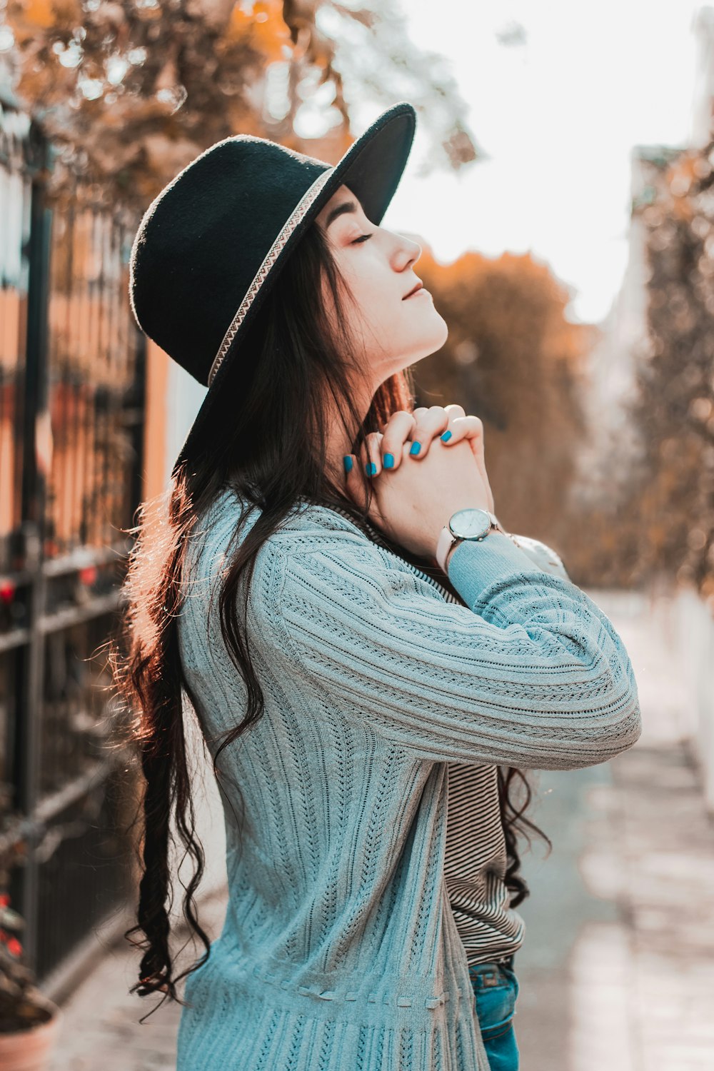 woman in black hat and gray sweater