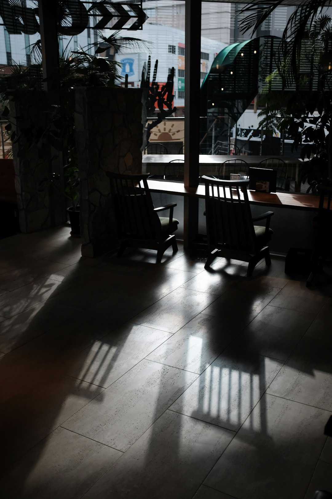 black wooden rocking chair on white floor tiles