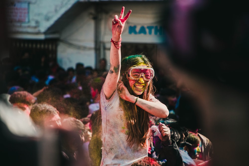 woman in white and red floral dress raising her hands