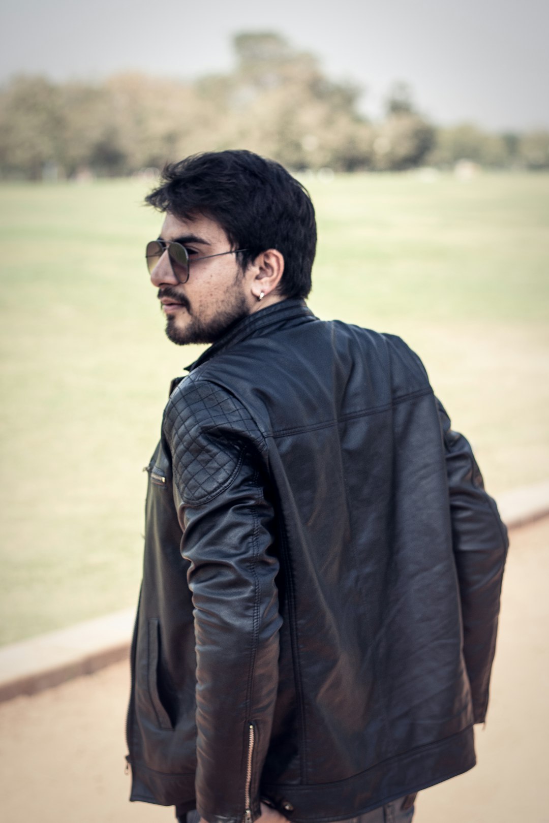 man in black jacket and brown backpack