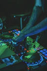 person playing audio mixer with green lights