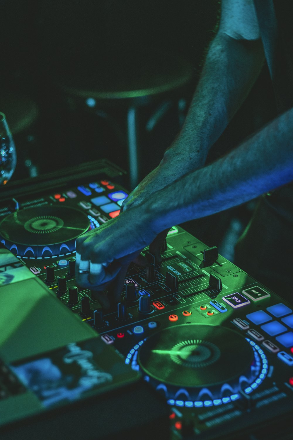 person playing audio mixer with green lights