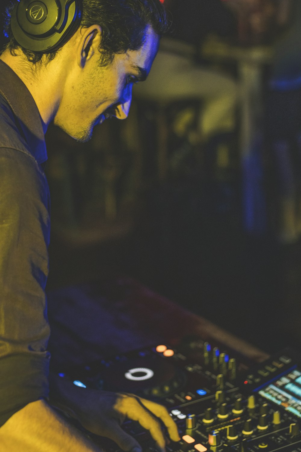 man in blue denim jacket playing dj controller