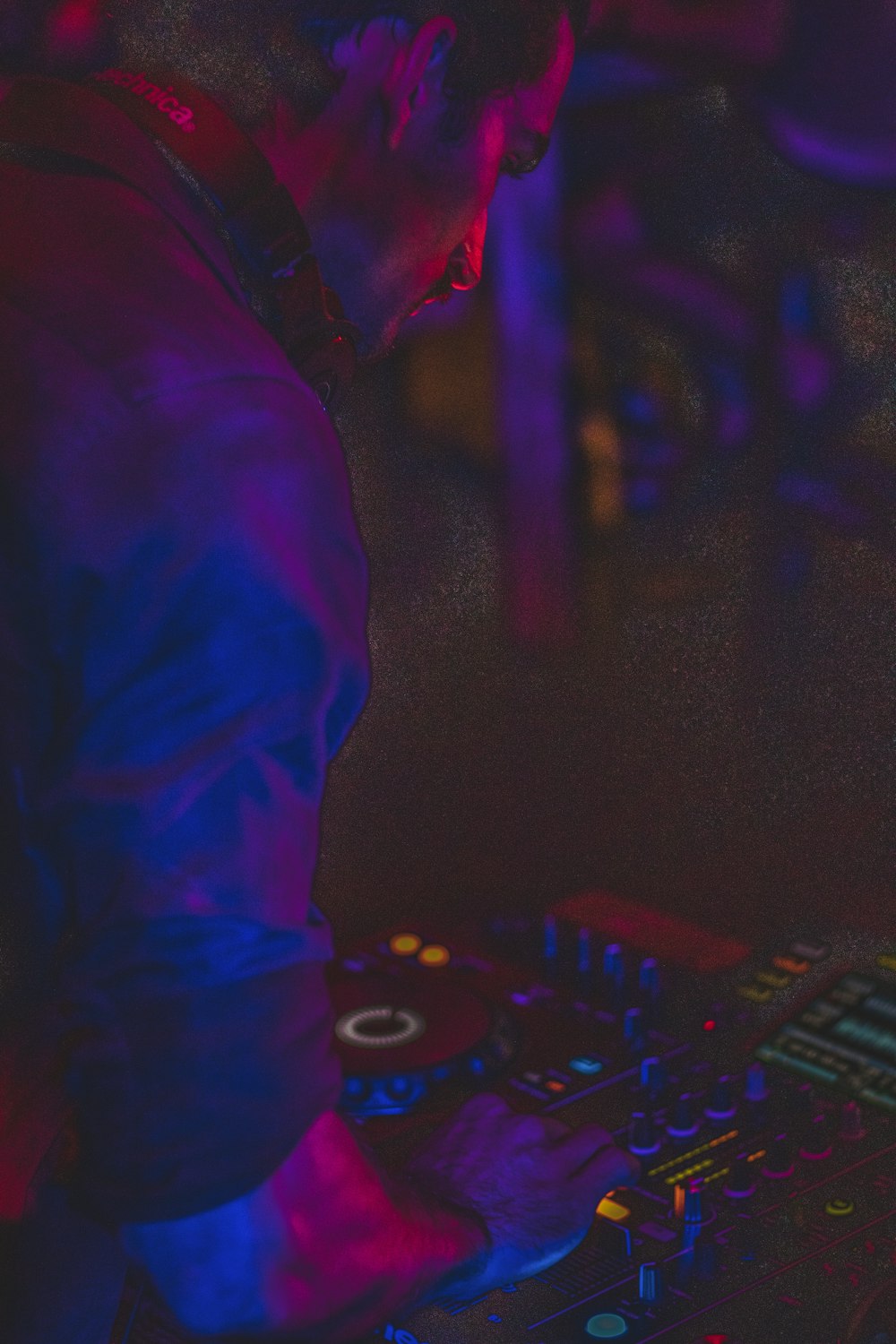 person in blue long sleeve shirt playing dj controller