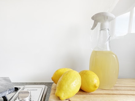 yellow lemon fruit beside clear glass bottle