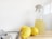 yellow lemon fruit beside clear glass bottle