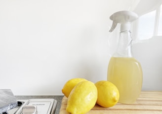 yellow lemon fruit beside clear glass bottle